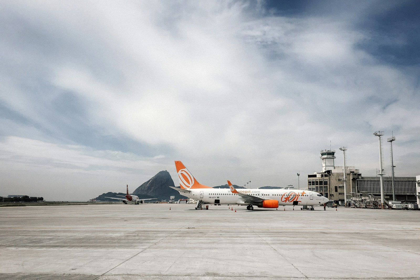 an orange and white airplane is on the runway